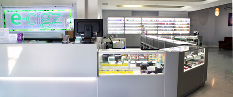 Modern vape store interior with a counter and electronic display board. Guelph, Ontario